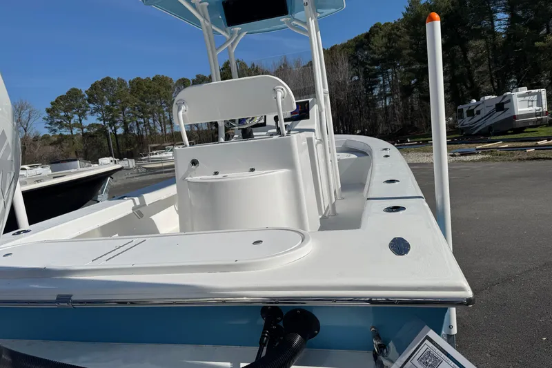 Slide: The Image of 2026 C-Hawk 23 Center Console boat with sleek design, parked outdoors under clear blue sky. - 11