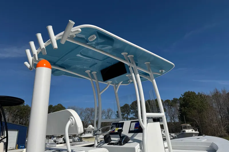 Slide: The Image of 2026 C-Hawk 23 Center Console boat with blue T-top under clear sky. - 12