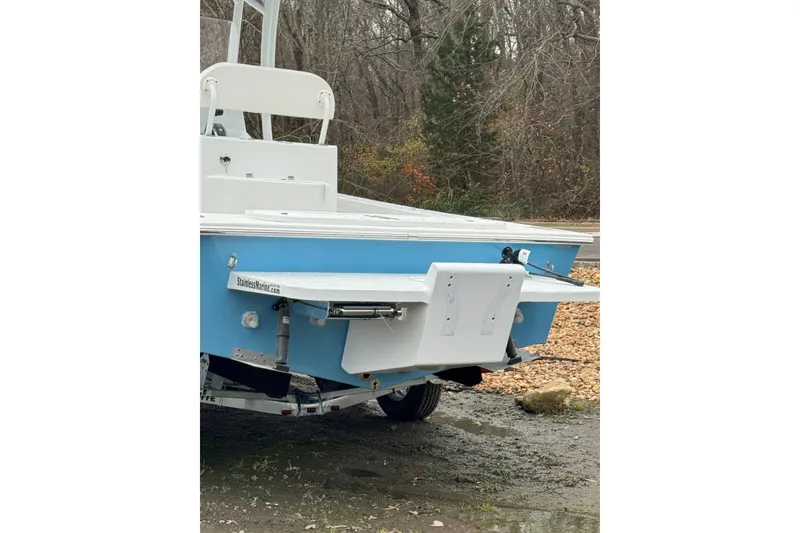 Slide: The Image of 2026 C-Hawk 23 Center Console boat, blue and white, rear view on trailer. - 6