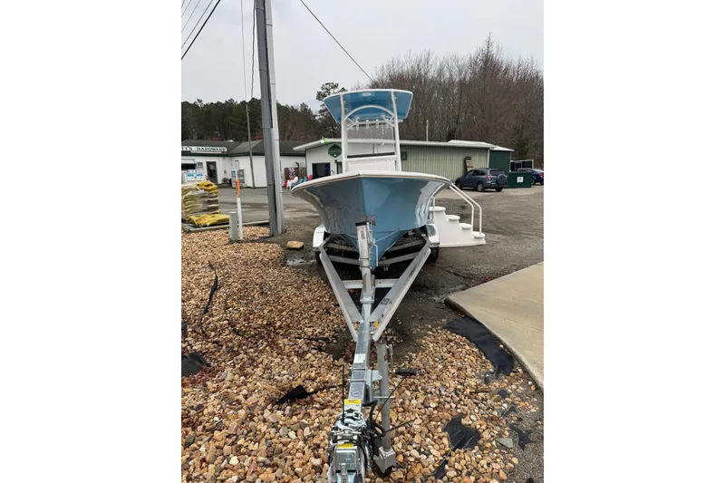 Slide: The Image of 2026 C-Hawk 23 Center Console boat on trailer, parked outdoors near a hardware store. - 7