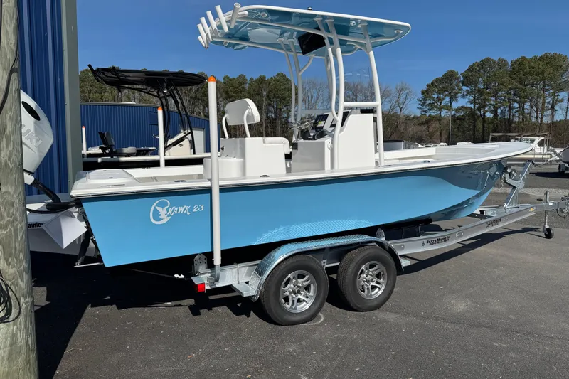 Slide: The Image of 2026 C-Hawk 23 Center Console boat on trailer, blue hull, parked outdoors. - 8