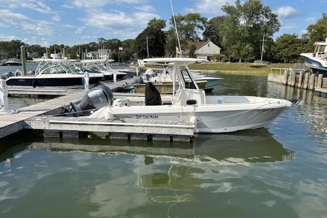 The Image of 2022 Edgewater 230CC boat docked in a marina with clear skies. - 0
