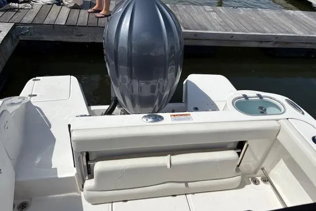 Slide: The Image of 2022 Edgewater 230CC boat stern with outboard motor and seating area. - 13