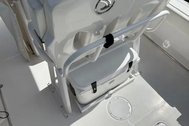 Slide: The Image of 2022 Edgewater 230CC boat interior with storage compartment and seating area. - 16