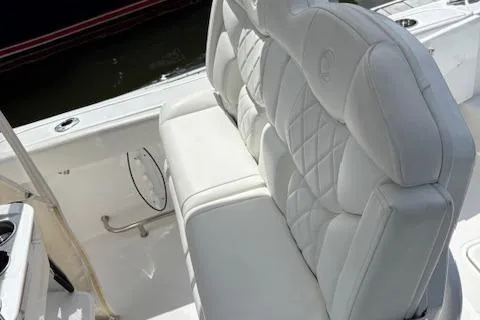 Slide: The Image of 2022 Edgewater 230CC boat with luxurious white seating and quilted design. - 18