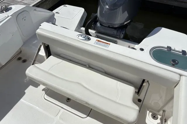 Slide: The Image of 2022 Edgewater 230CC boat interior with foldable seat and outboard motor. - 19