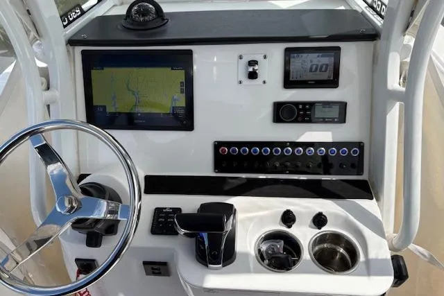 Slide: The Image of Edgewater 230CC 2022 boat dashboard with steering wheel, navigation screen, and control panel. - 4