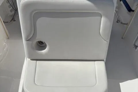 Slide: The Image of 2022 Edgewater 230CC boat seat with integrated cup holder, white upholstery. - 9
