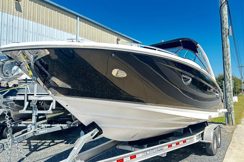 Slide: The Image of 2016 Regal 2800 Bowrider boat on trailer, black hull, outdoor display. - 1