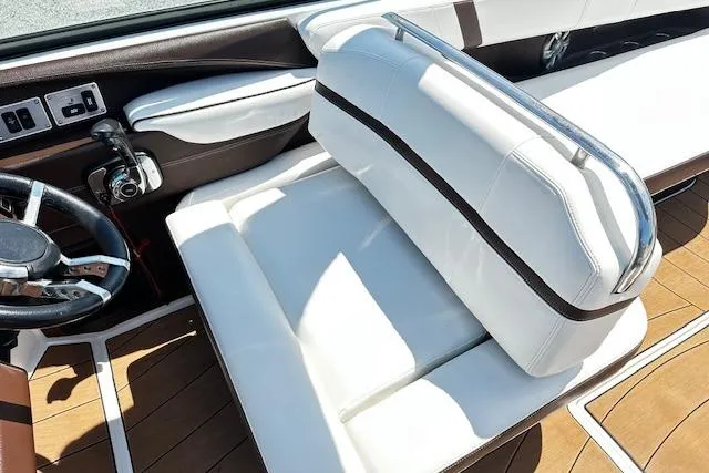 Slide: The Image of 2016 Regal 2800 Bowrider interior with white seating and wood accents. - 10