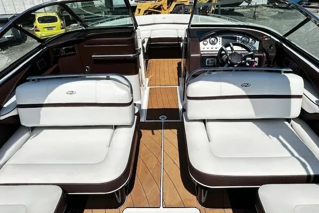 Slide: The Image of 2016 Regal 2800 Bowrider interior with white seating and wood flooring. - 11