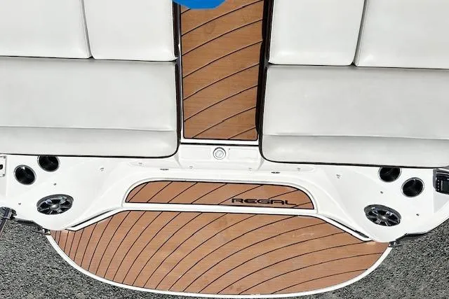 Slide: The Image of 2016 Regal 2800 Bowrider boat with teak-style deck and white seating. - 14