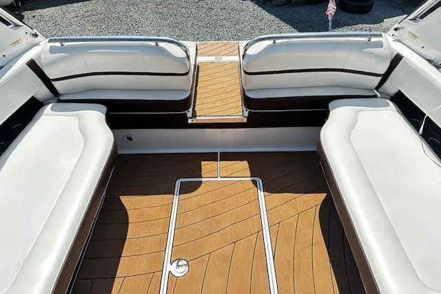 Slide: The Image of 2016 Regal 2800 Bowrider interior with white seating and teak flooring. - 15