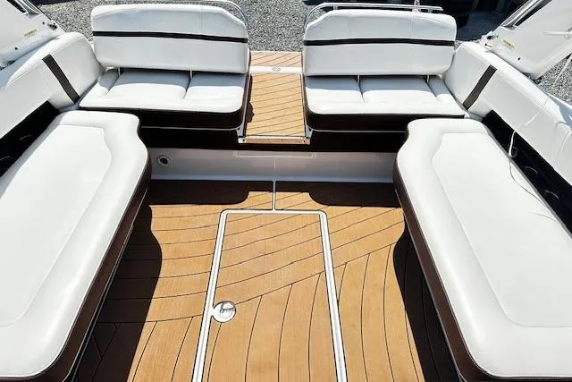 Slide: The Image of 2016 Regal 2800 Bowrider interior with white seating and wooden deck. - 16