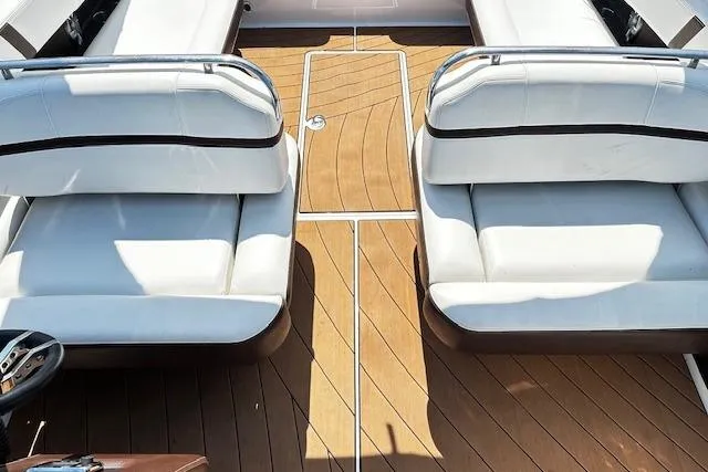 Slide: The Image of 2016 Regal 2800 Bowrider interior with white seating and wooden flooring. - 18