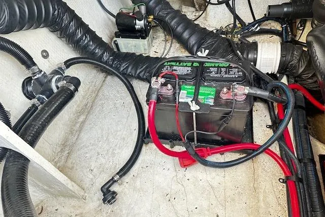 Slide: The Image of Battery and wiring inside a 2016 Regal 2800 Bowrider boat engine compartment. - 25