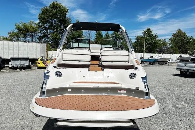 Slide: The Image of 2016 Regal 2800 Bowrider boat with spacious seating, parked outdoors under a clear sky. - 3