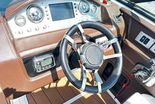 Slide: The Image of 2016 Regal 2800 Bowrider dashboard with steering wheel and control panel. - 4