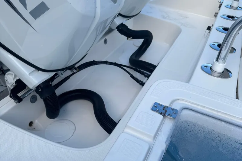Slide: The Image of 2026 Bulls Bay 255 boat engine compartment with hoses and fittings. - 12