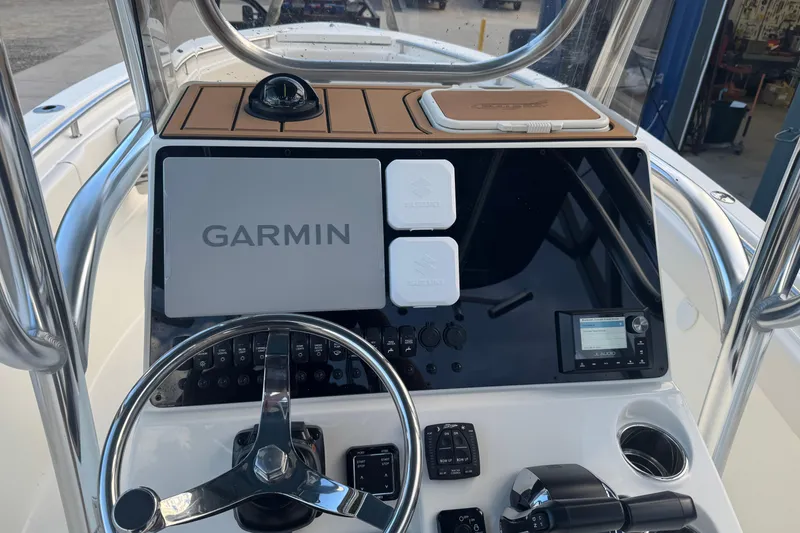 Slide: The Image of 2026 Bulls Bay 255 boat dashboard with Garmin navigation system and modern controls. - 13