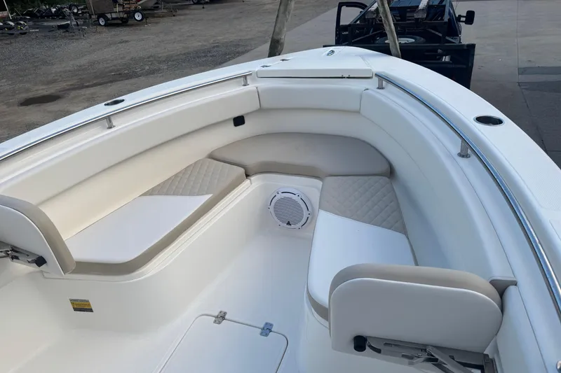 Slide: The Image of 2026 Bulls Bay 255 boat interior with cushioned seating and speaker system. - 16