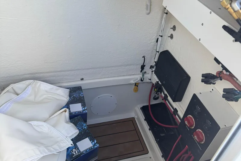 Slide: The Image of Interior view of 2026 Bulls Bay 255 boat showing electrical components and storage area. - 20
