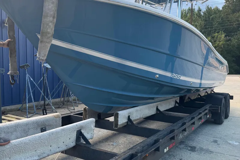 Slide: The Image of 2026 Bulls Bay 255 boat on trailer, blue hull, outdoor setting. - 3