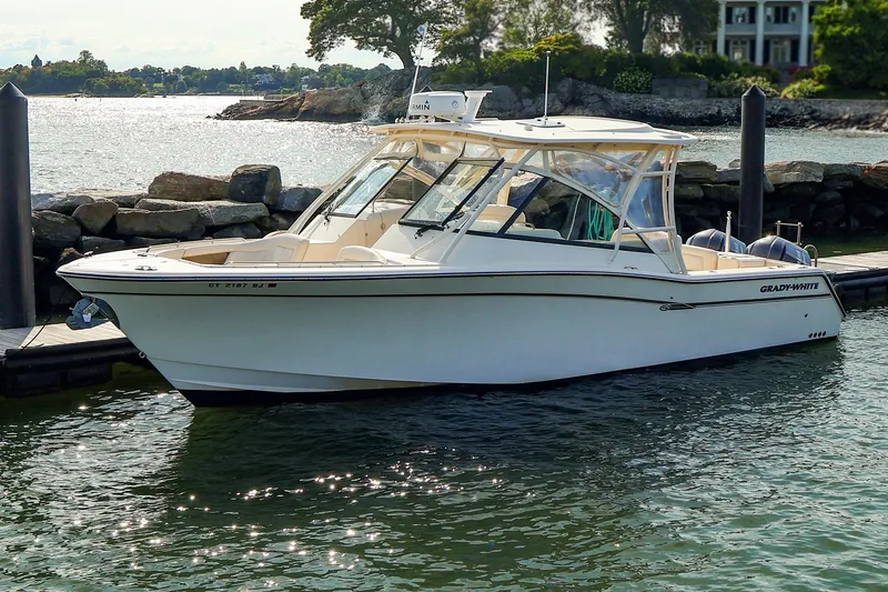 The Image of 2015 Grady White 335 Freedom boat docked by rocky shoreline. - 0
