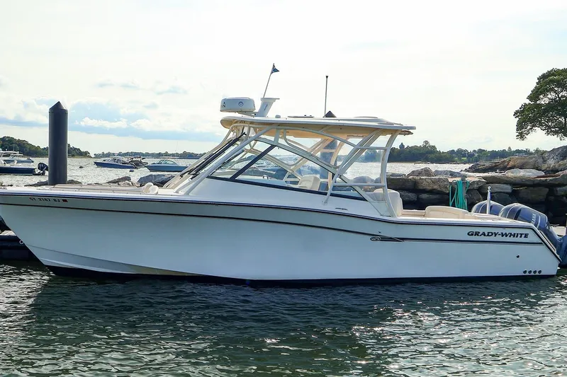 Slide: The Image of 2015 Grady-White 335 Freedom boat docked by the shore on a sunny day. - 1