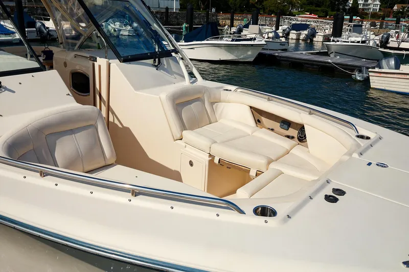 Slide: The Image of 2015 Grady White 335 Freedom boat interior with plush seating at marina. - 11