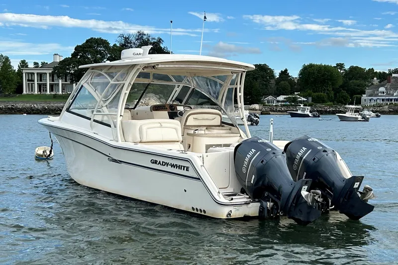 Slide: The Image of 2015 Grady-White 335 Freedom boat with twin Yamaha engines on a scenic lake. - 2