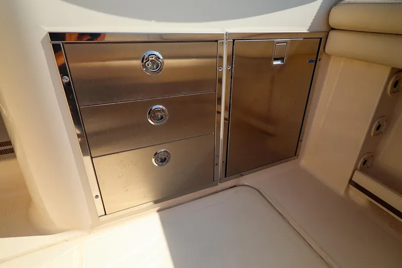 Slide: The Image of Stainless steel storage drawers on 2015 Grady White 335 Freedom boat interior. - 24