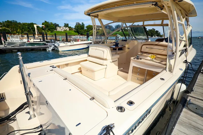Slide: The Image of 2015 Grady White 335 Freedom boat docked, featuring spacious seating and elegant design. - 26