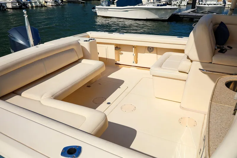Slide: The Image of 2015 Grady White 335 Freedom boat interior with beige seating and open deck. - 27