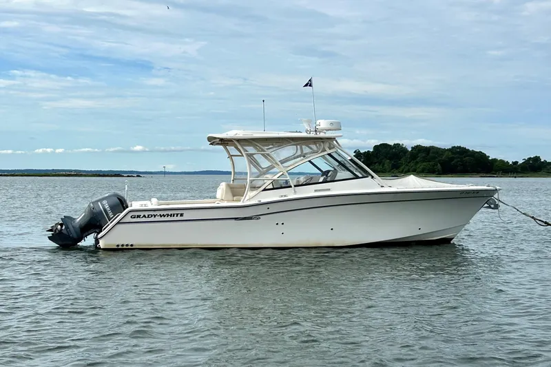 Slide: The Image of 2015 Grady-White 335 Freedom boat on calm water, side view. - 3