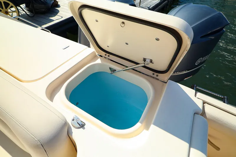 Slide: The Image of Open storage compartment on 2015 Grady White 335 Freedom boat, near Yamaha outboard motor. - 31