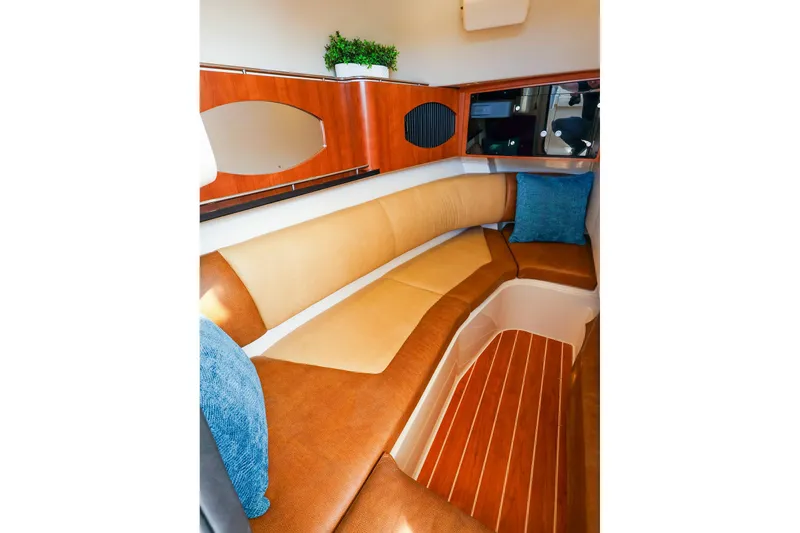 Slide: The Image of 2015 Grady White 335 Freedom cabin interior with cushioned seating and wooden accents. - 32