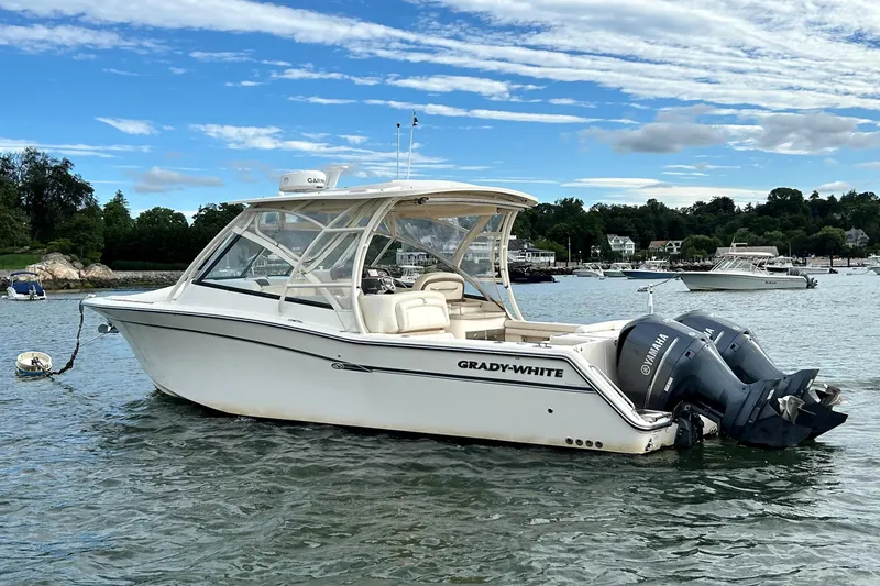 Slide: The Image of 2015 Grady-White 335 Freedom boat with twin Yamaha engines on a scenic lake. - 39