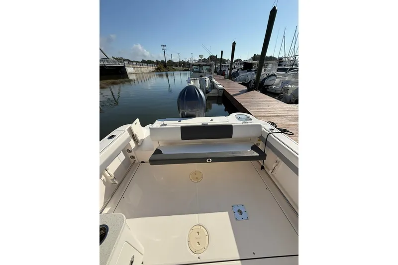Slide: The Image of 2022 Robalo R247 Dual Console boat docked at marina, rear view. - 10