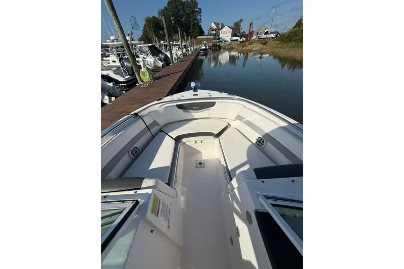Slide: The Image of 2022 Robalo R247 Dual Console boat docked at marina, interior view. - 22