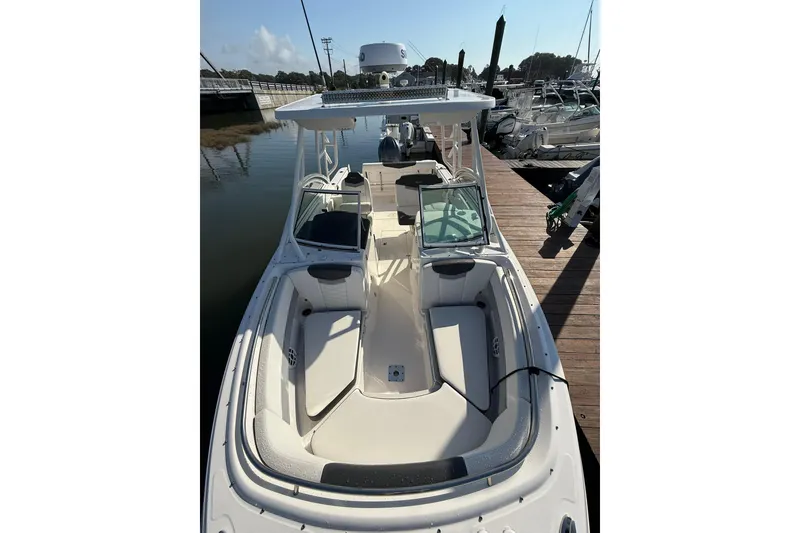 Slide: The Image of 2022 Robalo R247 Dual Console boat docked at marina, showcasing spacious seating. - 4