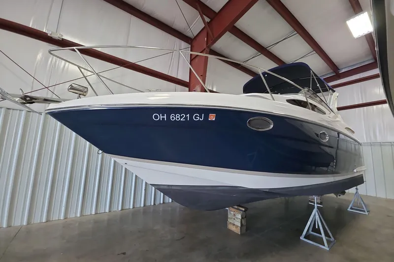 The Image of 2007 Regal 2860 Window Express boat in storage, blue and white hull. - 0