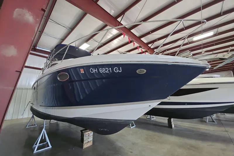 Slide: The Image of 2007 Regal 2860 Window Express boat in indoor storage, blue and white hull. - 1