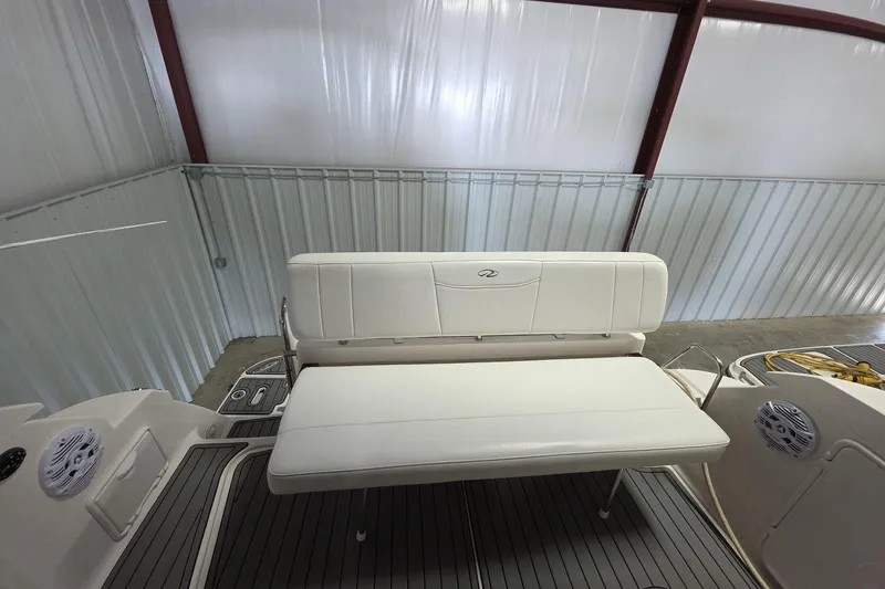 Slide: The Image of 2007 Regal 2860 Window Express boat interior with white seating and speakers. - 6