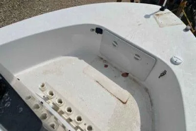 Slide: The Image of 2000 Falcon Striper boat interior with storage compartments and rod holders. - 10