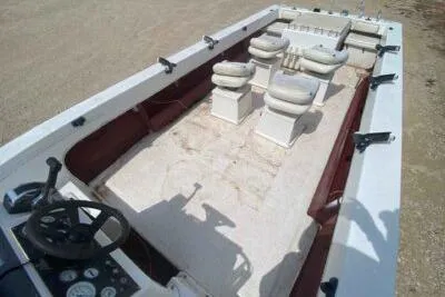 Slide: The Image of 2000 Falcon Striper boat interior with seating and steering wheel, viewed from above. - 11