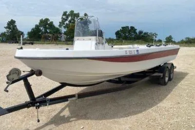 Slide: The Image of 2000 Falcon Striper boat on trailer in outdoor setting. - 4
