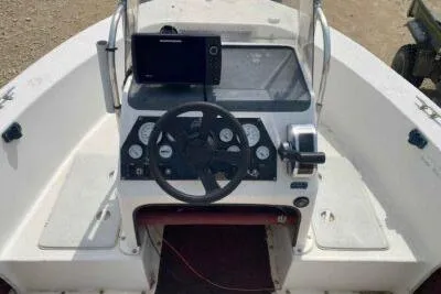 Slide: The Image of Cockpit of 2000 Falcon Striper boat with steering wheel and navigation equipment. - 9