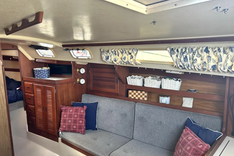 Slide: The Image of Interior of 1987 Catalina 30 Mk II sailboat with cozy seating and nautical decor. - 13