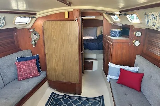 Slide: The Image of Interior of 1987 Catalina 30 Mk II sailboat with cozy seating and nautical decor. - 14